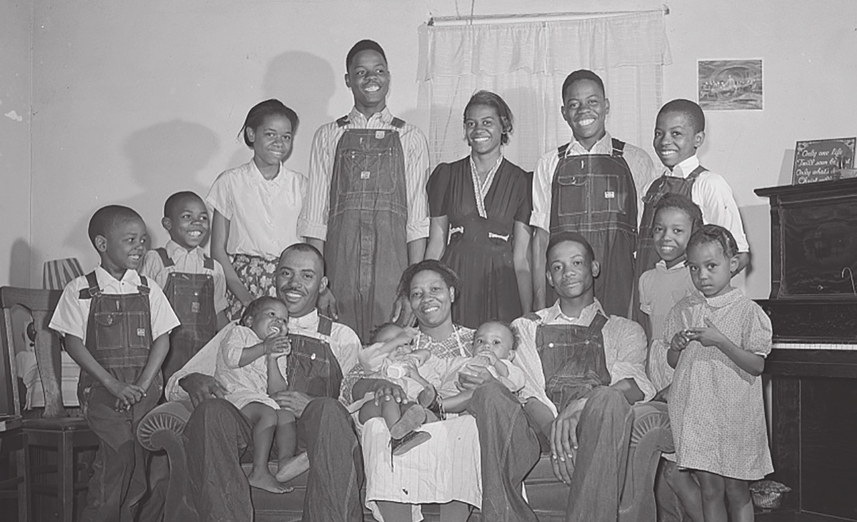 Mr. and Mrs. Feggen Jones at home with their large family, circa 1940s