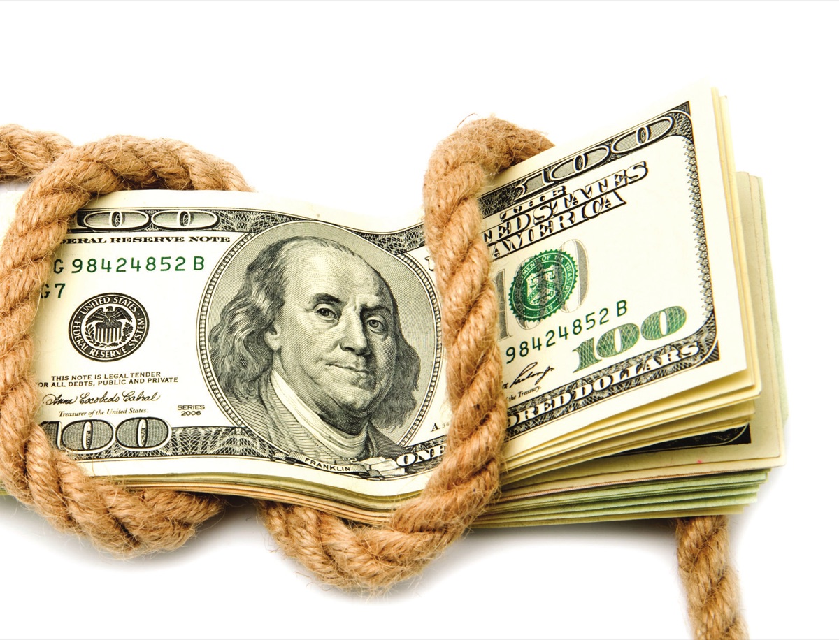 A stack of hundred-dollar bills bound with rope
