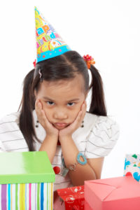 a girl wearing a party hat over a white background