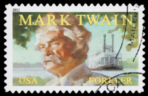 Sacramento, California, USA - September 27, 2011: A 2011 United States postage stamp with an illustration of Mark Twain (the pseudonym of Samuel Clemens, 1835-1910), with a steamboat in the background. The stamp was designed by Phil Jordan and Gregory Manchess, using a portrait of Twain photographed around 1907.