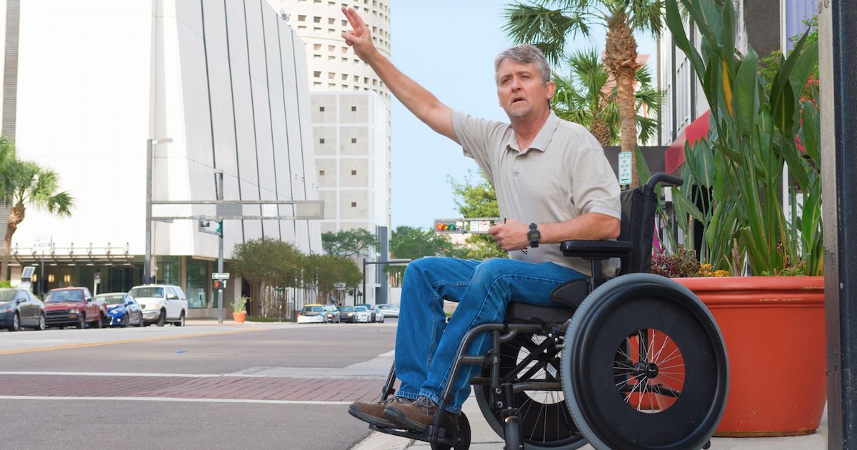 Man in Wheelchair hailing an Uber disability