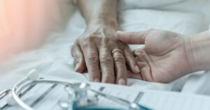 hospital bed holding hands