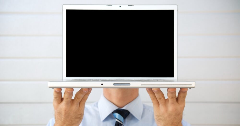 businessman hiding behind computer screen virtual meeting